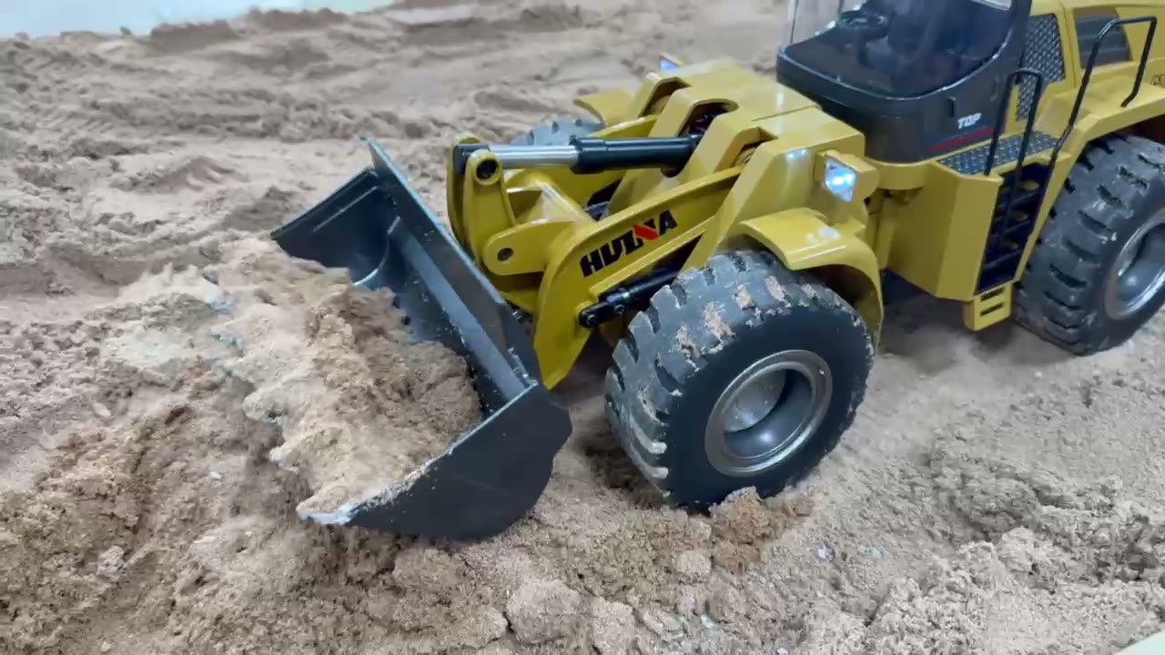 RC dozer and loader working the sand on the Construction Works site